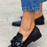 Black loafer with shiny bow