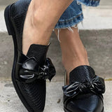 Black loafer with shiny bow