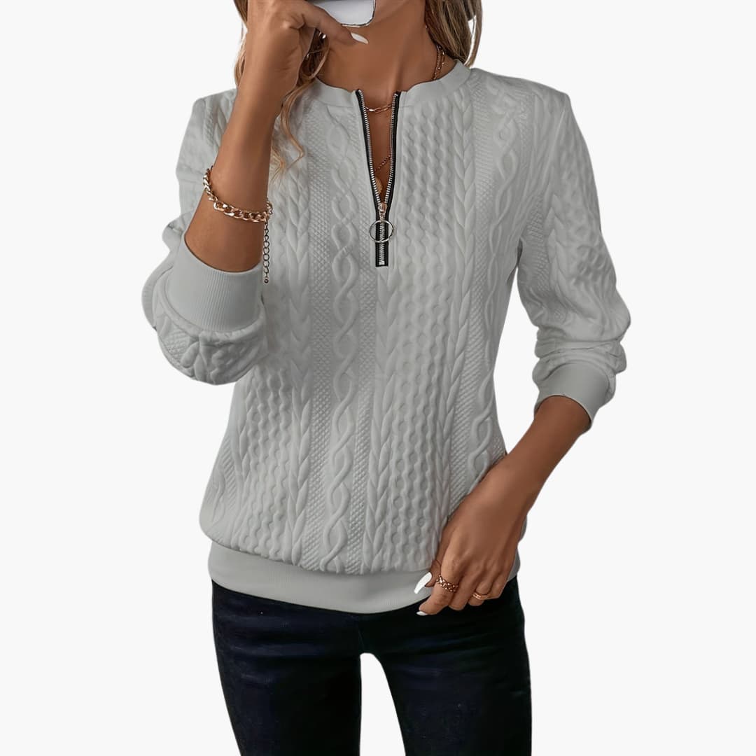 Women's pullover with zipper at the neckline and cable knit surface