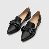 Black loafer with shiny bow